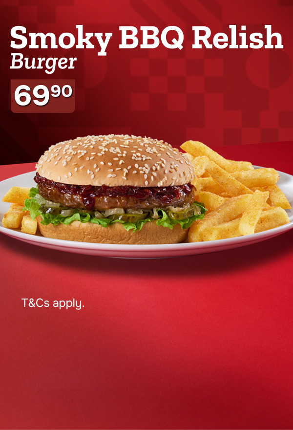 Classic hamburger with a sesame seed bun, a saucy patty, fresh lettuce, and pickles, accompanied by chips